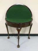 A mahogany d-shaped card table on claw and ball feet CONDITION REPORT: Surface wear