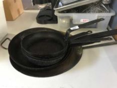 A quantity of commercial frying pans