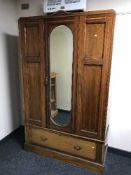 An inlaid mahogany mirror door wardrobe