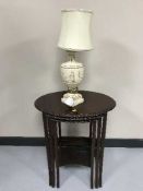 A nest of three oval mahogany tables and a classical chalk table lamp