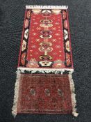 A small fringed woollen Afghan mat and another rug