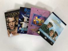 A box of DVDs and DVD box sets