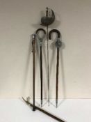 A fencing foil, two shooting sticks,