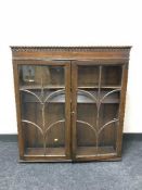 An oak glazed door bookcase