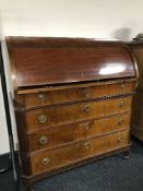 A late 19th century mahogany barrel fronted bureau