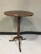A mahogany pedestal wine table