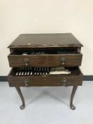 A mahogany cutlery chest containing a part canteen of plated cutlery