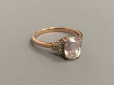 A 9ct gold dress ring set with a pale pink stone
