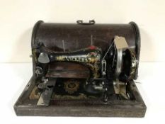 A cased Vickers hand sewing machine and a vintage leather luggage case