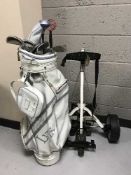 Two golf bags containing clubs and an electric golf trolley