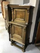 An early 20th century carved oak double cupboard