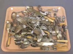 A tray containing a large quantity of plated flatware