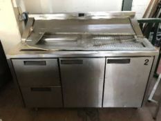 A stainless steel refrigerated counter