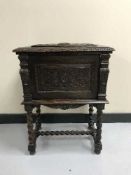A heavily carved oak sewing box CONDITION REPORT: Split to top.
