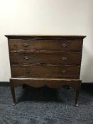 A George III oak three drawer chest with brass drop handles