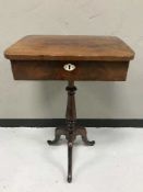An antique mahogany sewing table on three way pedestal