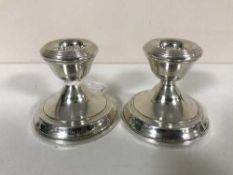 A pair of silver dwarf candlesticks,