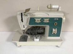 A cased Singer electric sewing machine