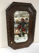An early 20th century oak framed bevel edged mirror