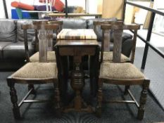 An oak drop leaf table and four chairs,