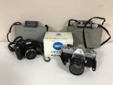 A box of cameras including Polaroid, Yashika TL Electro X,
