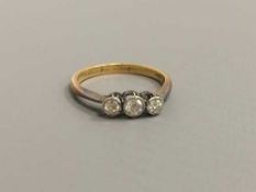 An 18ct gold three stone diamond ring