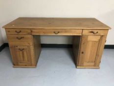 A contemporary pine twin pedestal PC desk