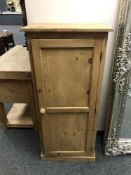 A pine single door cupboard