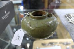 A Chinese Song Period earthenware bowl, in olive glaze with twin handles, height 7.