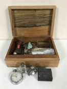 A box of stop watch, whistles, perfume bottles, coins,
