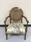 A walnut framed cane backed armchair