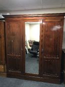 A late Victorian mahogany triple door wardrobe CONDITION REPORT: The left door is