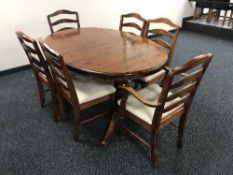 An oval Ducal Pine extending dining table and six chairs
