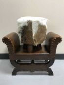 A leather upholstered child's stool and a hide stool