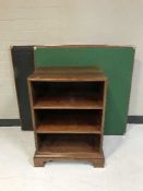 A set of open bookshelves and two folding cards tables