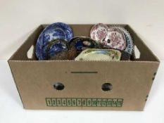 Two boxes of wall plates, coloured glass ware, Spode bowl,