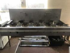 A large stainless steel nine ring commercial cooking range