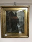 An early 20th century gilt framed oil - figure with harbour beyond