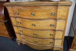 A late 19th century continental oak serpentine fronted four drawer chest on paw feet