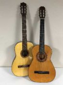 Two acoustic guitars in carry bags with manuals and accessories