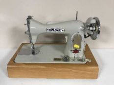 A cased Diplomat electric sewing machine