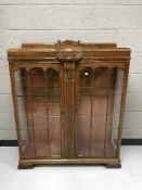 A carved oak display cabinet
