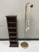 A contemporary CD rack and an adjustable brass standard lamp