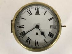 A circular brass-cased ship's timepiece (recently serviced by the vendor)