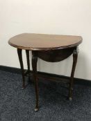 A mahogany drop leaf table on cabriole legs