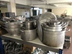 A large quantity of aluminium cooking pans, cutlery, serving platters,