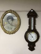 A heavily carved oak cased barometer and an antiquarian gilt framed portrait