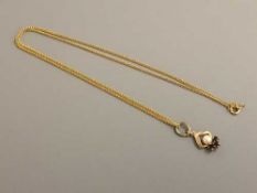 A 9ct gold pearl and garnet pendant on chain