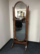 A contemporary cheval mirror on stand