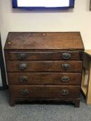 A Victorian oak bureau on bracket feet